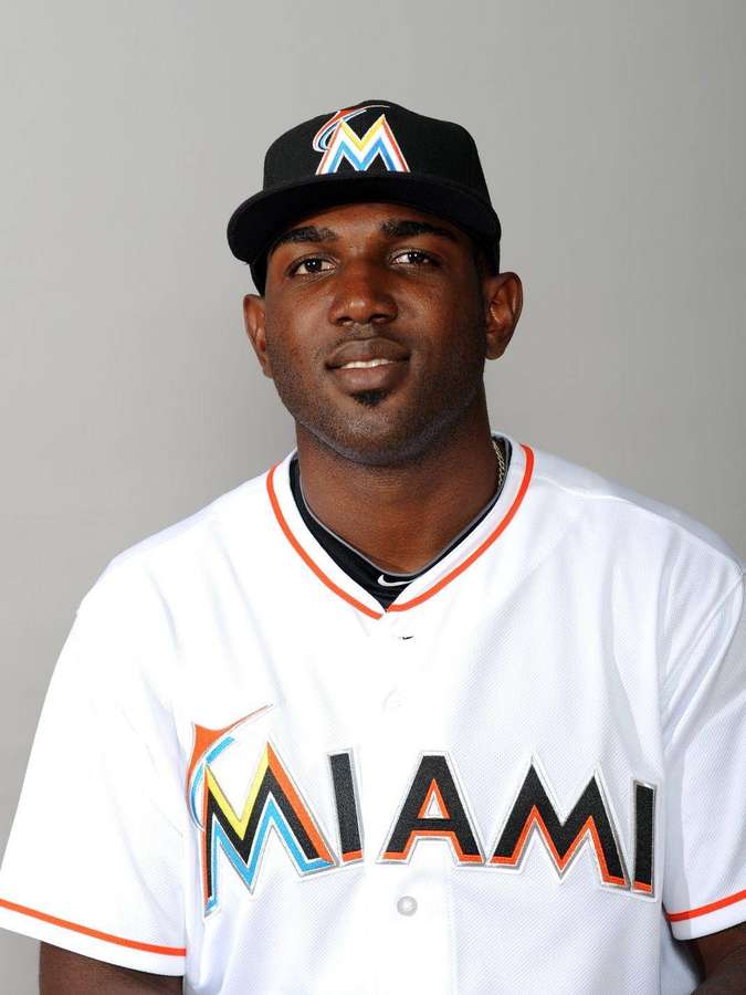 Baseball player wearing Miami Marlins uniform and cap in studio portrait. — Marlins Wallpaper