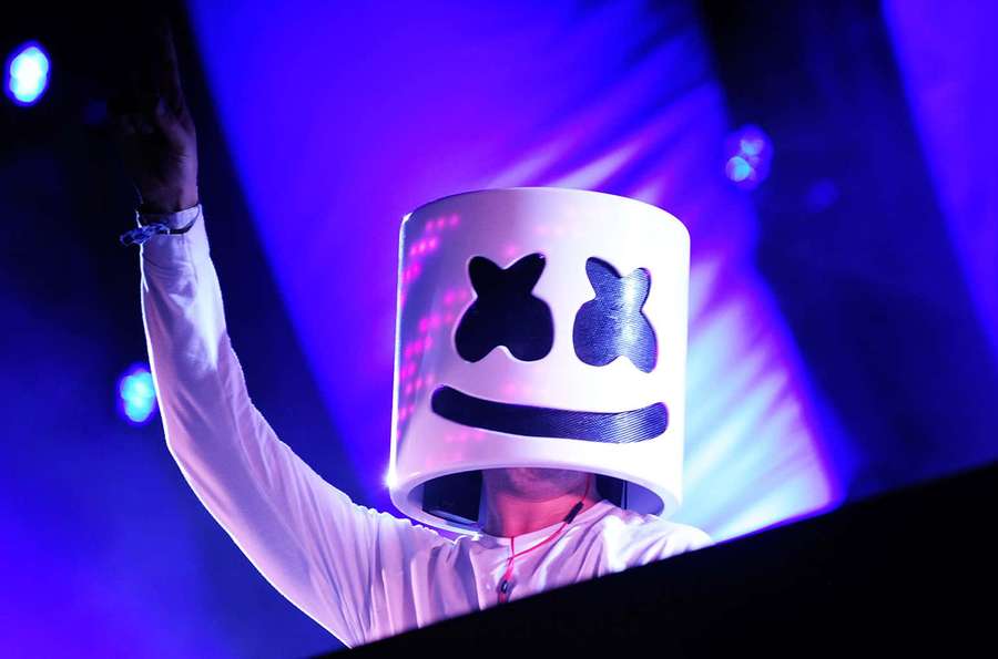 DJ Marshmello performing at a concert wearing his signature white helmet. — Marshmello Picture