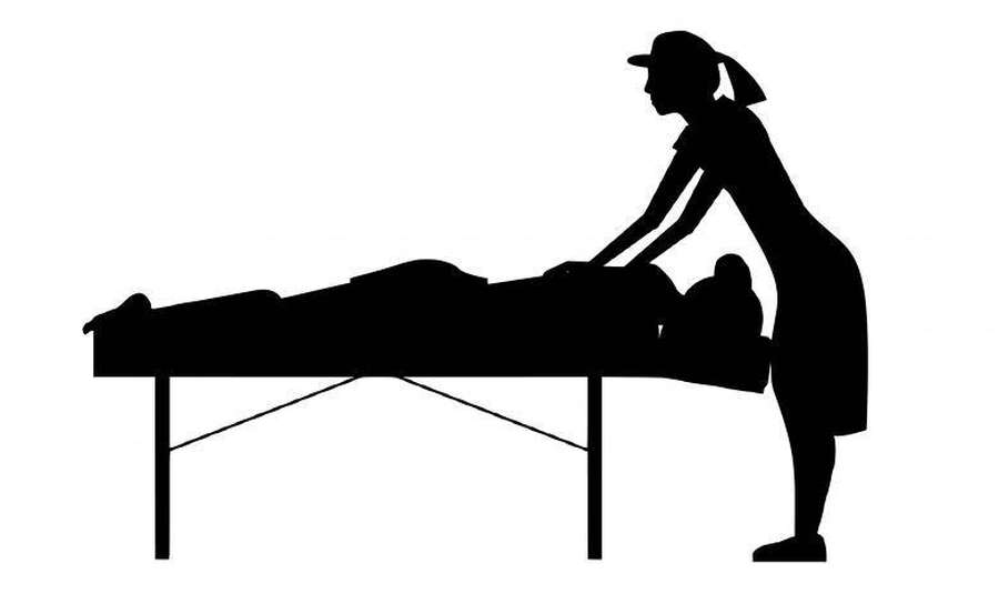 Therapist giving a massage to a client on a table. — Massage Wallpaper