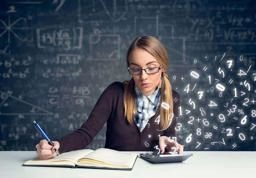 Student solving math problems with floating numbers and a chalkboard behind her. — Math Picture
