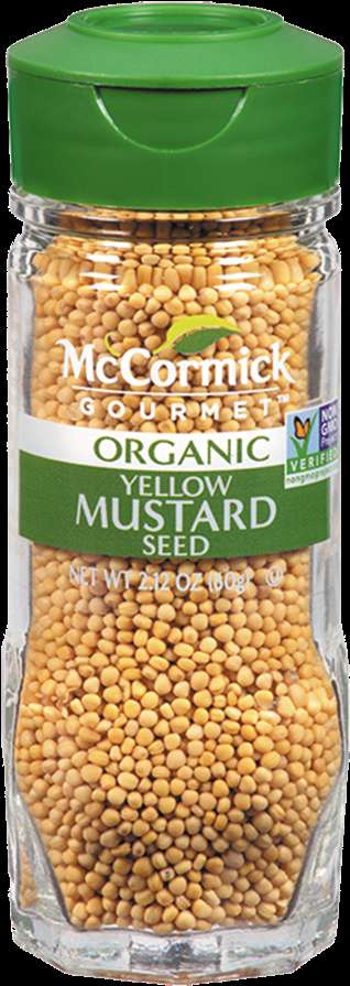 A jar of organic yellow mustard seeds with green lid and label. — Mccormick Background
