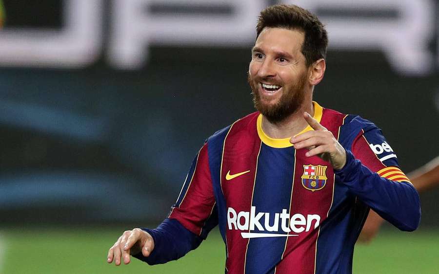 Lionel Messi celebrating in his Barcelona soccer jersey on the field at night. — Messi 2021 Wallpaper