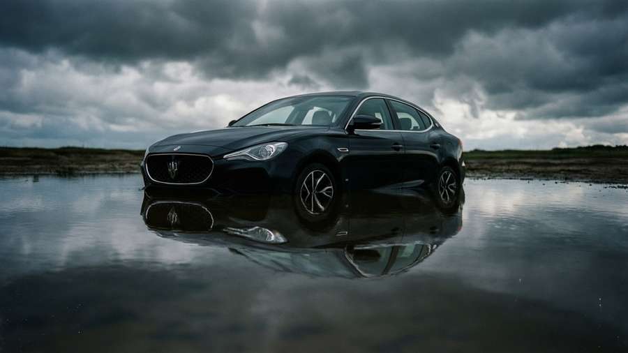 MG 6 with symmetrical reflection in water under dramatic sky. — Mg 6 Wallpaper