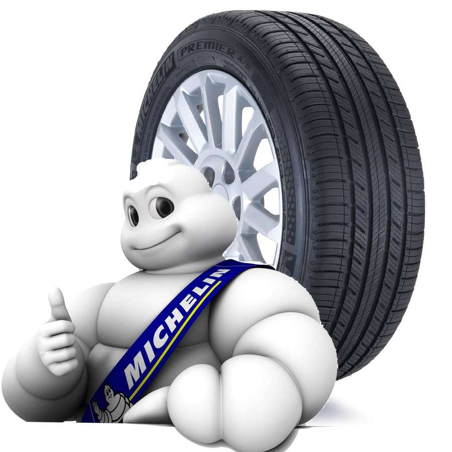 Mascotte dell'Uomo Michelin che fa pollice in su accanto a un pneumatico Michelin. — Michelin Sfondi