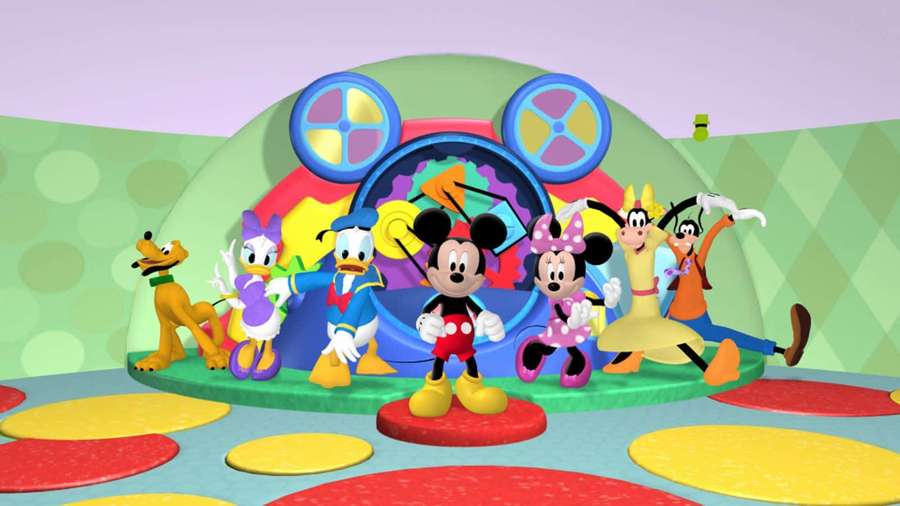 Disney characters Mickey Minnie Donald Daisy Goofy and Pluto posing on a colorful playground. — Mickey Mouse Home Wallpaper