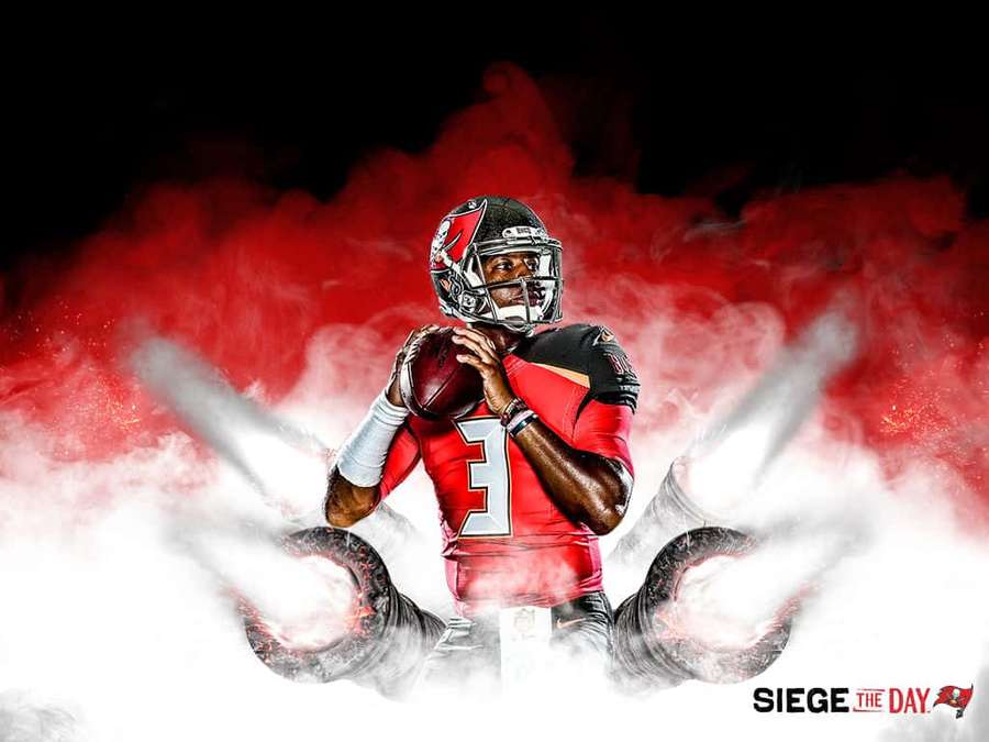 Football player in red jersey holding ball surrounded by smoke and fire effects. — Mike Evans Wallpaper