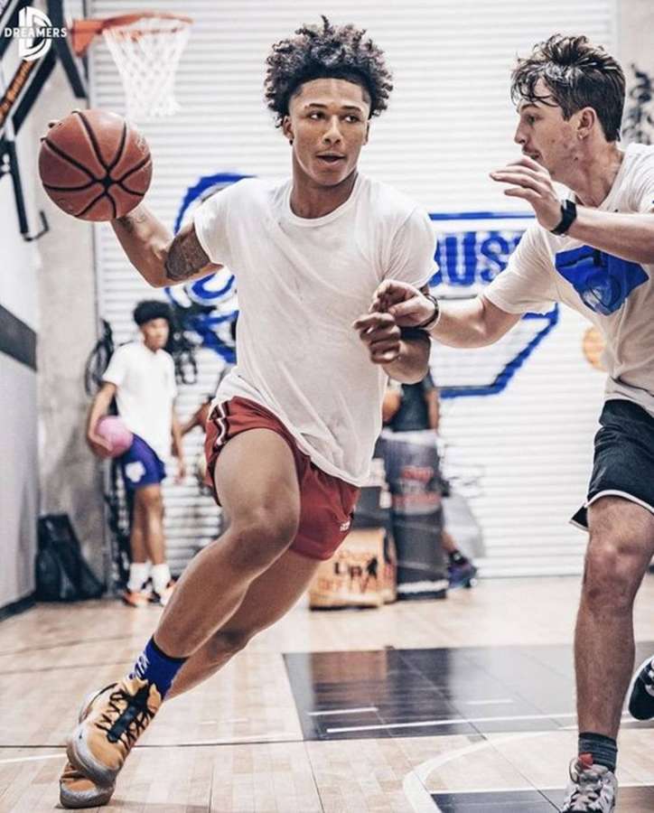 Young basketball players competing in an indoor gym during a game. — Mikey Williams Wallpaper