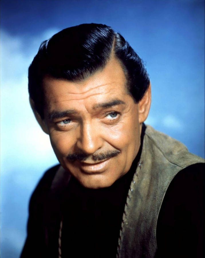 Portrait of a smiling man with a mustache wearing a vest against a blue sky. — Mitchell Background