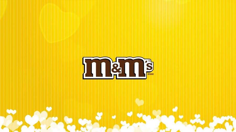 M&M's logo on yellow striped background with white heart bokeh — Mms Wallpaper