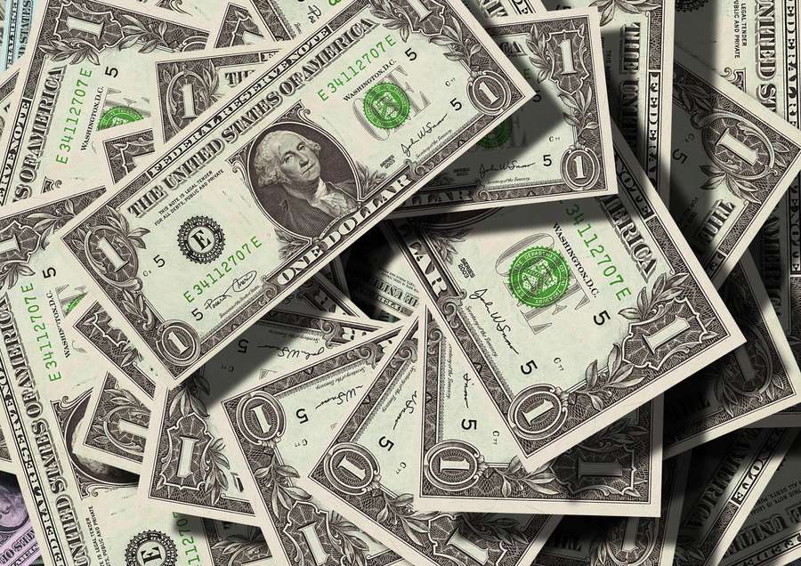 Scattered one-dollar bills with green seals and shadows. — Money Background