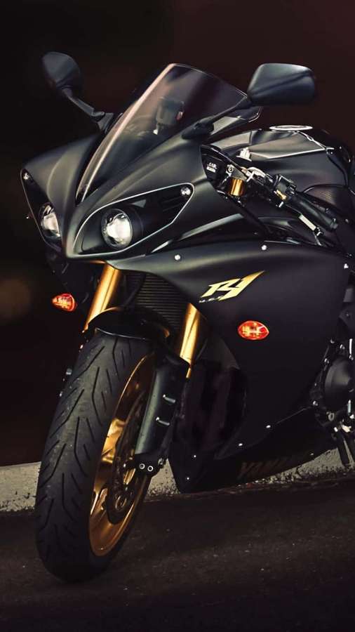 Moto esportiva preta elegante com garfos dourados estacionada na calçada. — Moto iPhone Papéis de Parede
