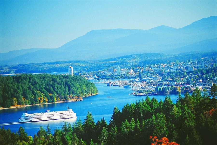 Cruise ship sailing through a scenic harbor with mountains and forests in the background. — Nanaimo Wallpaper