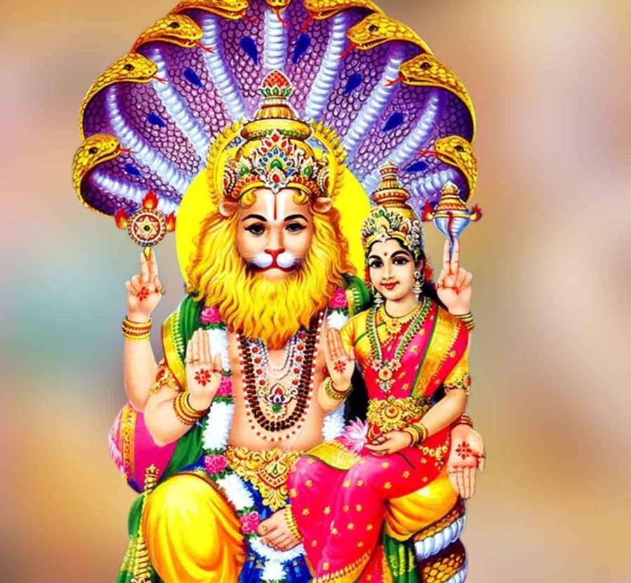 Lord Shiva and Parvati seated together under a serpent crown, adorned in vibrant traditional attire. — Narasimha Wallpaper