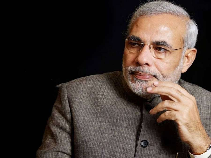 A man in a gray suit and glasses with a thoughtful expression. — Narendra Modi Wallpaper