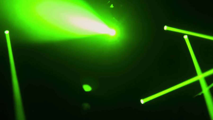 Green laser lights illuminate a dark stage during a live performance. — Neon Green Background