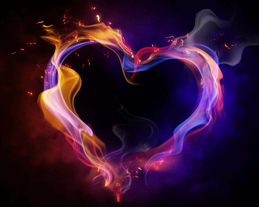 A glowing heart formed by swirling fire and smoke in vibrant colors. — Neon Heart Wallpaper