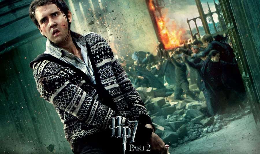 Young wizard in battle amidst rubble and flames — Neville Longbottom Wallpaper