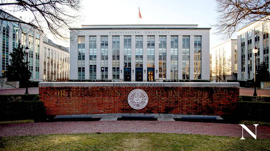 Northeastern University Krentzman Quadrangle building with brick sign and glass facade. — Northeastern University Wallpaper