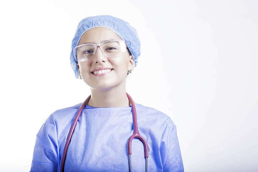 Smiling female surgeon in blue scrubs and cap with stethoscope. — Nursing Wallpaper