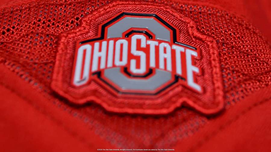 Red Ohio State University sports jersey patch with white and gray logo. — Ohio State Background