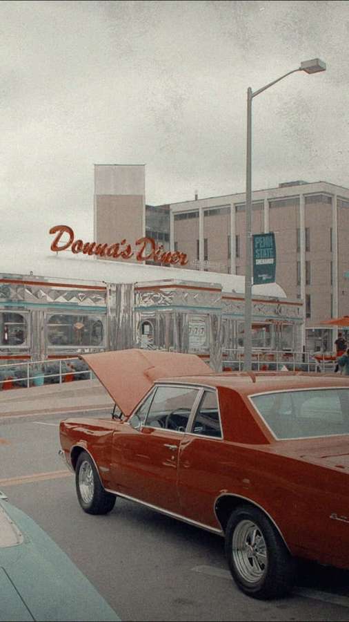 Red classic car with open hood parked outside Donna's Diner on a cloudy day. — Old School Mobile Wallpaper