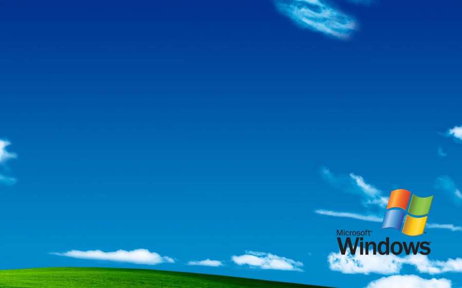 Green hill under blue sky with Microsoft Windows logo — Old Windows Wallpaper