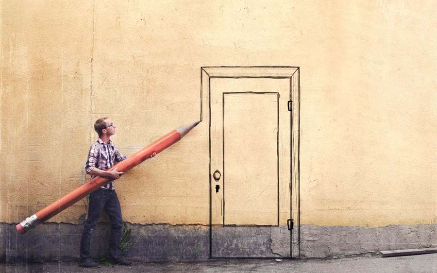 Man holding giant pencil about to draw door on wall — Opportunity Wallpaper