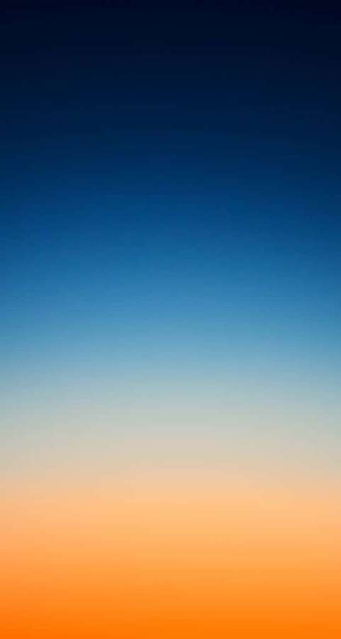 Gradient sky transitioning from blue to orange at sunset — Orange And Blue Background
