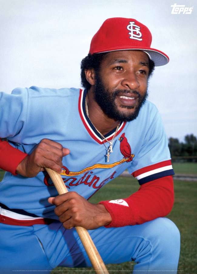 Baseball player in Cardinals uniform crouching with wooden bat outdoors. — Ozzie Smith Wallpaper