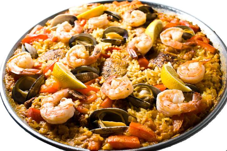 A plate of seafood paella with shrimp mussels peppers and lemon wedges. — Paella PNG