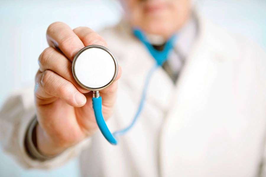 A doctor extends a blue stethoscope toward the viewer. — Physician Background