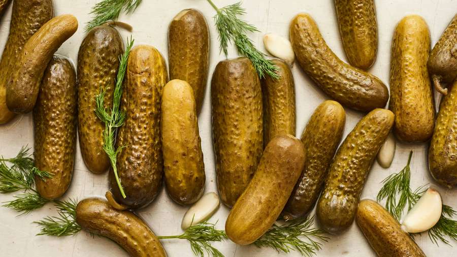 Pickles med dill og hvitløksfedd på en treoverflate. — Pickle Bakgrunner