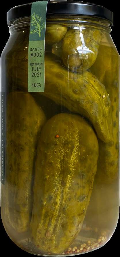 A jar of pickled cucumbers with spices and a best before date label. — Pickle PNG