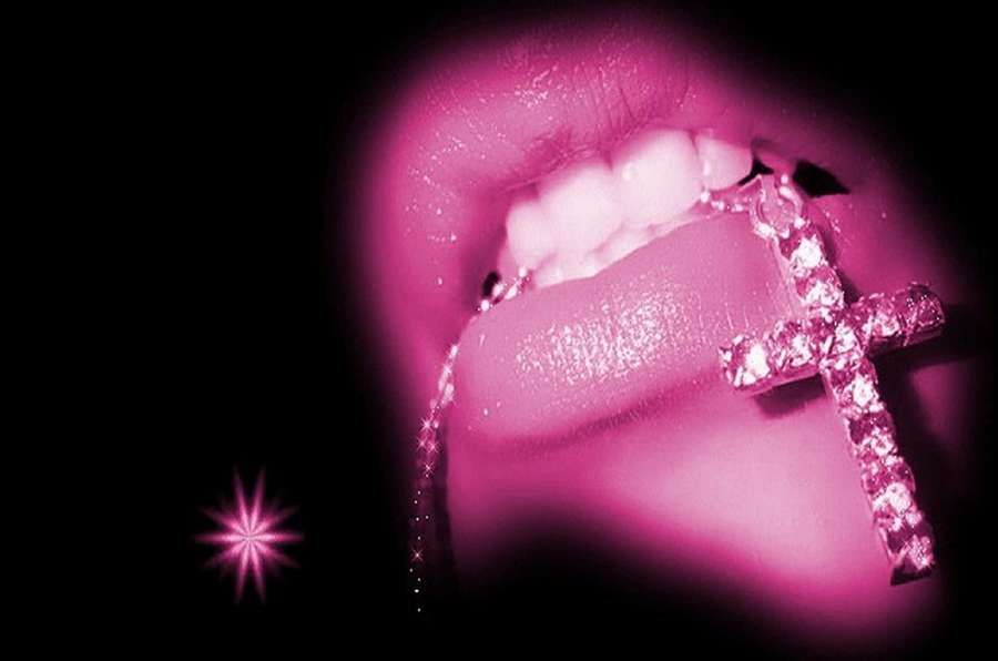 Lips holding a diamond cross necklace with pink lighting and starburst effect. — Pink Lips Wallpaper