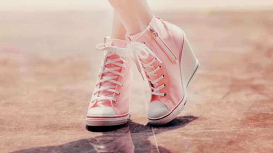 Pink high-top wedge sneakers with white laces on a reflective pavement. — Pink Shoes Wallpaper