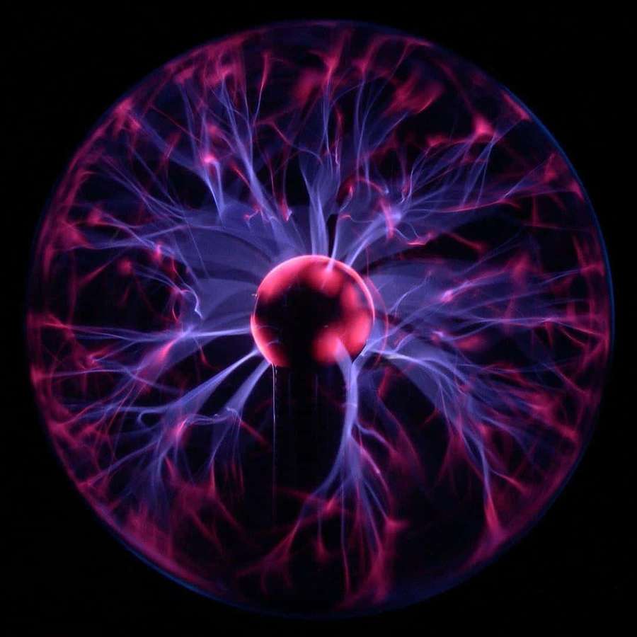 A glowing plasma ball with electric tendrils in purple and pink against black. — Plasma Wallpaper