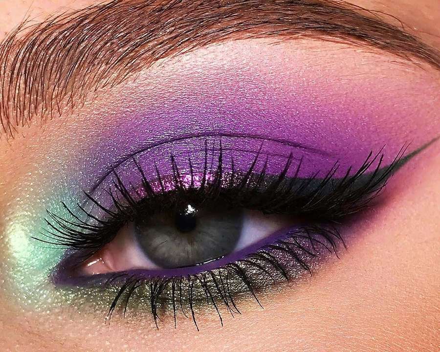 Close-up of an eye with purple and teal glitter makeup and long lashes. — Purple Eye Shadow Wallpaper