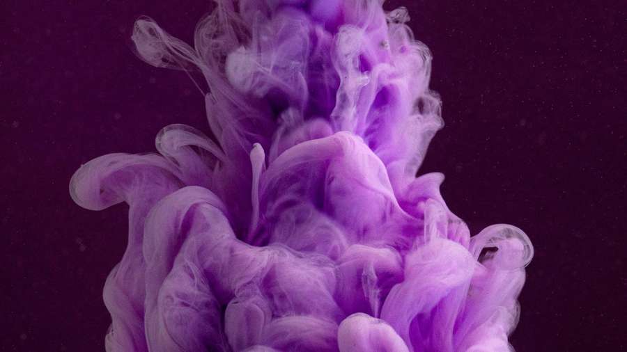 Purple ink swirling in water against a dark background — Purple Ink Wallpaper