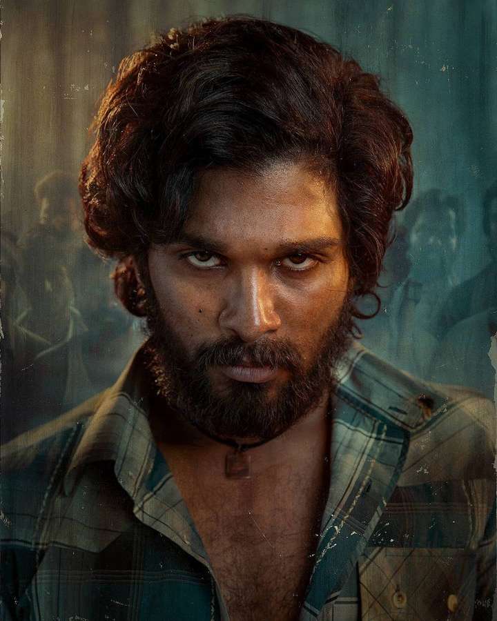 Close-up portrait of a bearded man with intense gaze wearing a plaid shirt. — Pushpa Allu Arjun Wallpaper