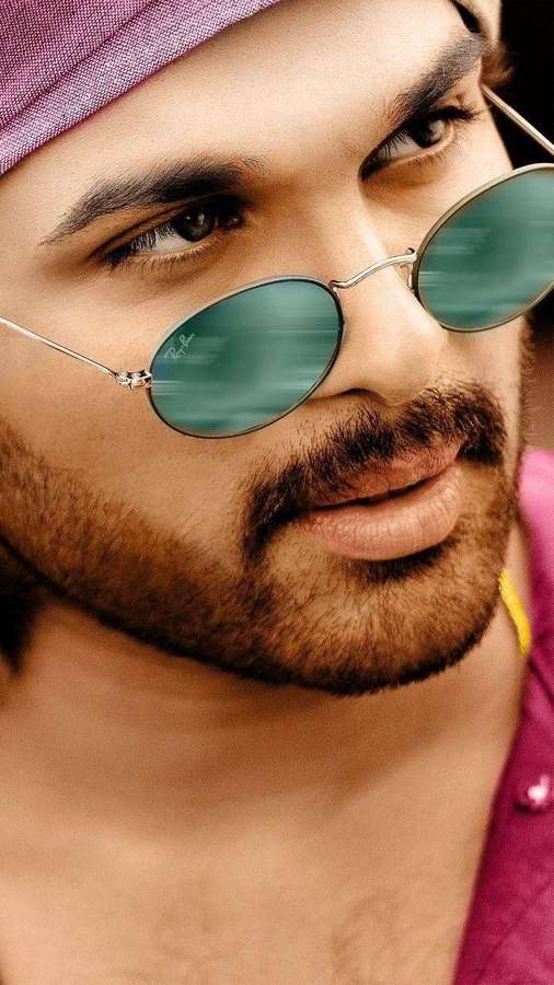 Man with beard wearing round green sunglasses and purple headwrap and shirt. — Pushpa Picture