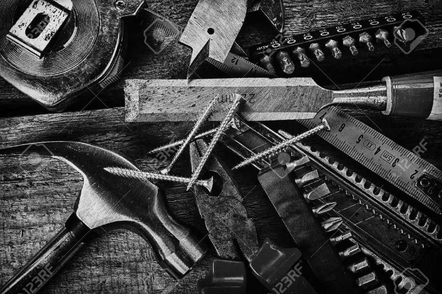 Kokoelma vintage-metallityökaluja säänkestetyllä puupinnalla mustavalkoisena. — Puusepät Taustakuvat
