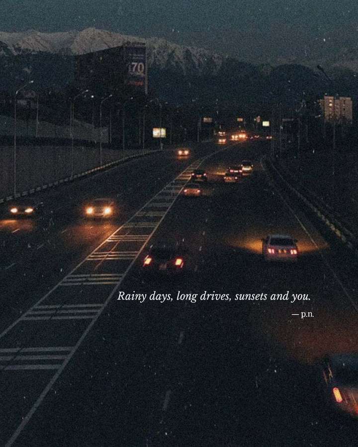 Cars drive on a rainy highway at dusk with snow-capped mountains in the background. — Quotes Rainy Days Wallpaper