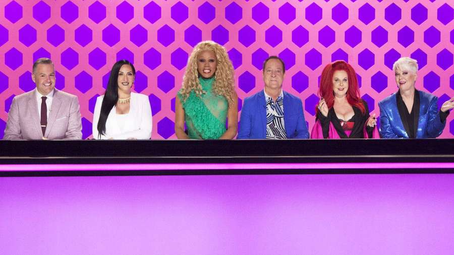 Six diverse hosts on a purple hexagonal set with colorful outfits and expressive poses. — Race Background