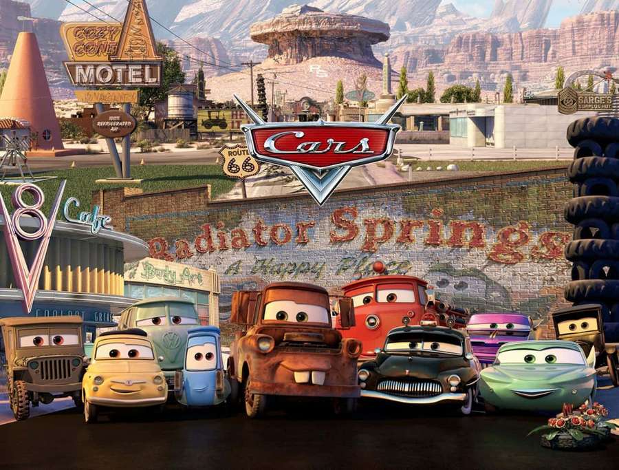 Group of animated cars posing in front of a town mural in a desert setting. — Radiator Springs Wallpaper