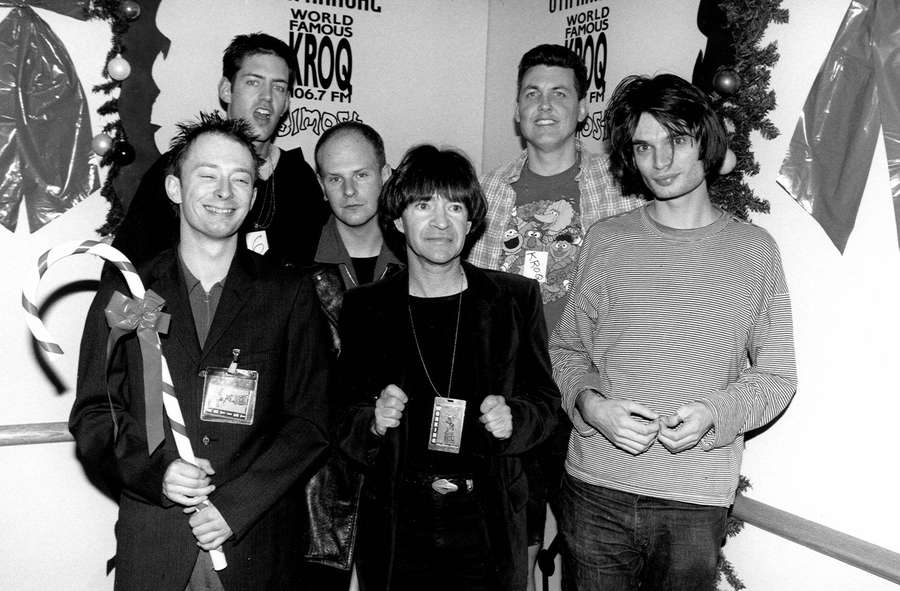 Five men posing at a holiday radio station event with candy cane and decorations. — Radiohead Wallpaper