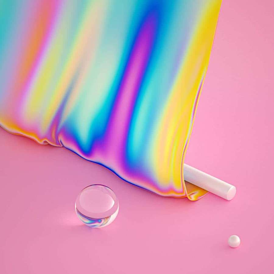 Iridescent fabric with glass sphere and chalk on pink background. — Rainbow Aesthetic Background
