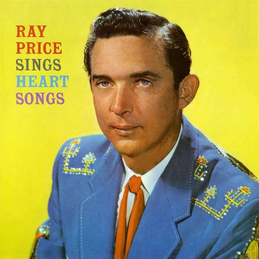 Ray Price in a blue suit with orange tie on a yellow background. — Ray Price Wallpaper