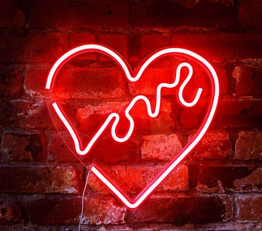 Red neon heart sign with love word on brick wall — Red Led Wallpaper