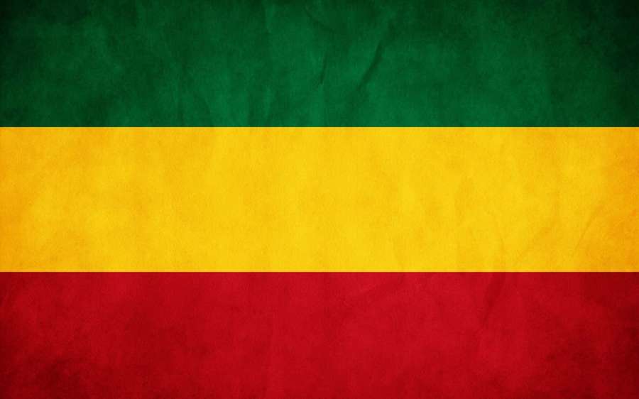 Vintage strukturierte Flagge mit grünen, gelben und roten horizontalen Streifen. — Reggae Hintergrundbild
