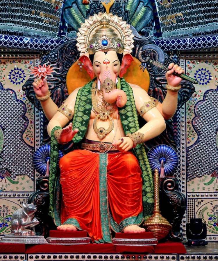 Estátua colorida do deus hindu Ganesha sentado em um trono ornamentado com cabeça de elefante e múltiplos braços. — Rei Lalbaugcha Papéis de Parede